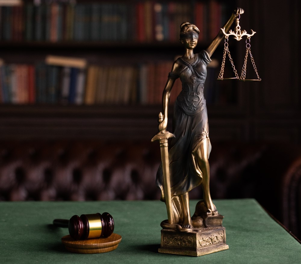 a court hammer and lady justice in a lawyers office