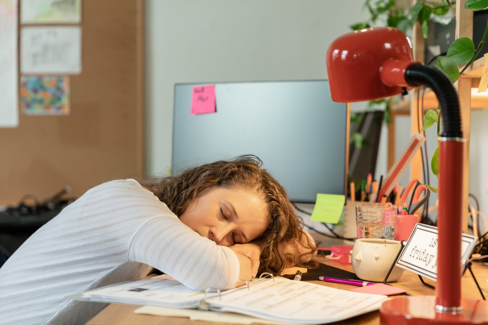 an employee falls asleep at their desk due to burnout