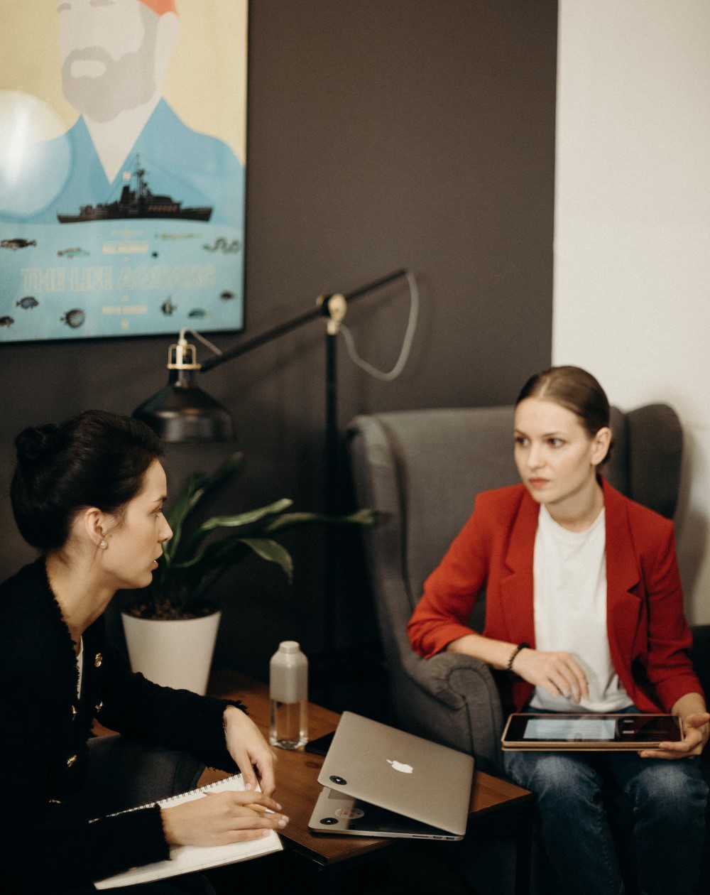 two women have a meeting in an office at a desk