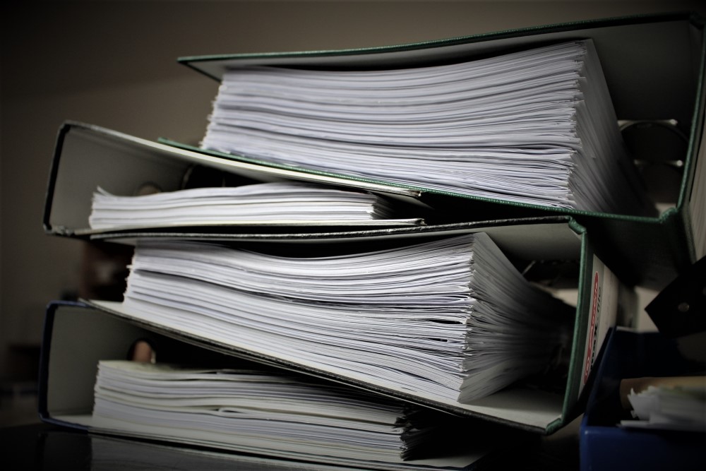 a stack of folders with documents in them 