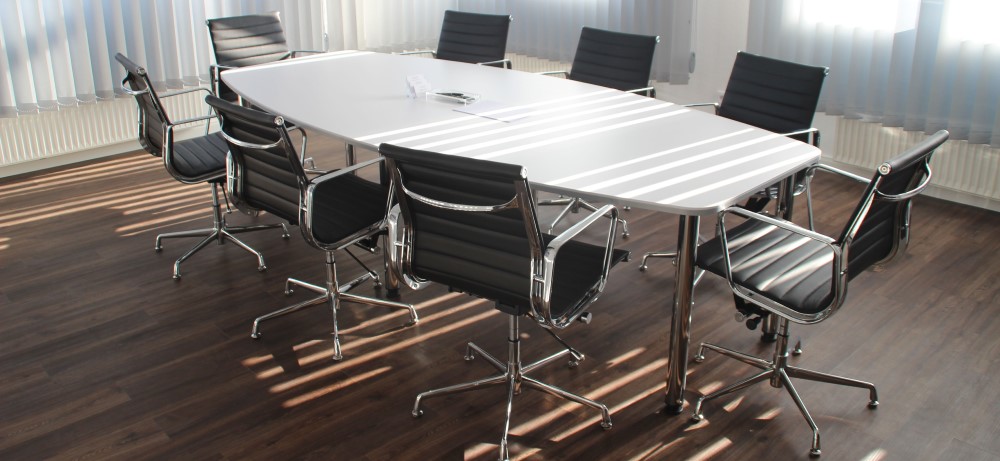 an empty meeting room with chairs and a table